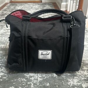 Black Herschel diaper bag with changing pad